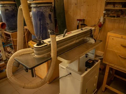 Carpentry workshop. Joiner's machines. A machine for sanding the surface of w Stock Photos
