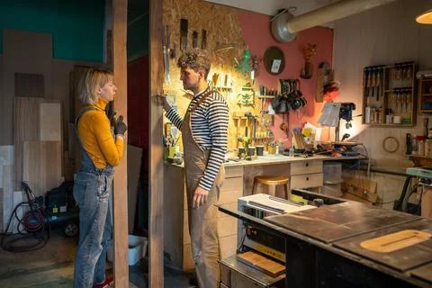 Carpentry workshop, joiners working together. Carpenters chatting in between Stock Photos