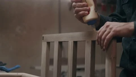Carpentry workshop. Putting wood glue onto a wooden board. Bonding wood in the Stock Footage 230922411