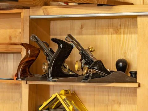 Carpentry workshop. There are three planers of different sizes on a wooden sh Stock-Fotos