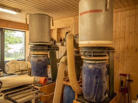 Carpentry workshop. Two large stationary vacuum cleaners for removing sawdust Stock Photos