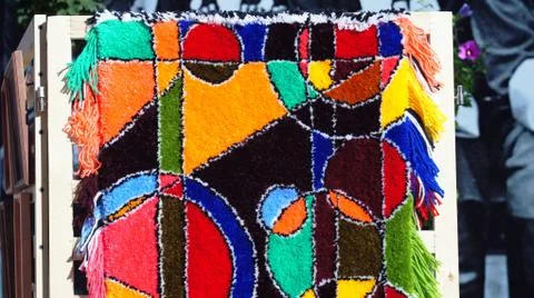 A carpet with an abstract pattern made by hands. Stock Photos