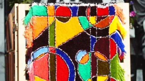 A carpet with an abstract pattern made by hands. Stock Photos