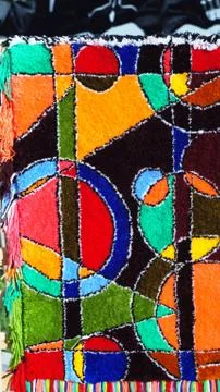 A carpet with an abstract pattern made by hands. Stock Photos