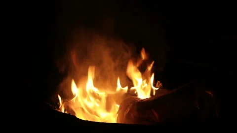 The carpet burns in a round garbage can at night. close-up. Stock Footage 85902582