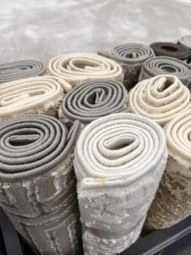 Carpet rolls viewed from above featuring layered woven textures and refined.. Fotos de archivo