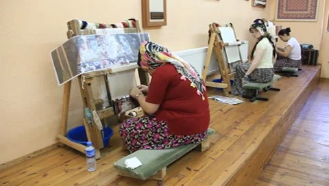 Carpet weaving. Turk womans make a silk carpet Stock Footage