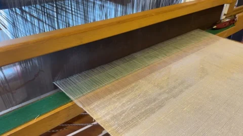 Carpet weaving using traditional techniques on a loom. , close-up of weaving and Stock Footage 283574531
