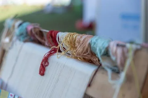 Carpet weaving using traditional techniques on a loom. , close-up of weaving and Stock Photos