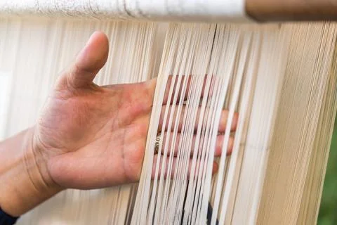Carpet weaving using traditional techniques on a loom. , close-up of weaving and Stock Photos