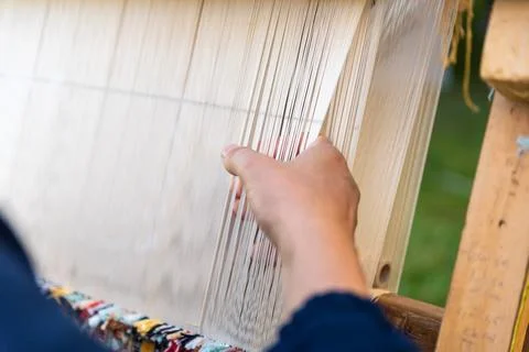Carpet weaving using traditional techniques on a loom. , close-up of weaving and Stock Photos
