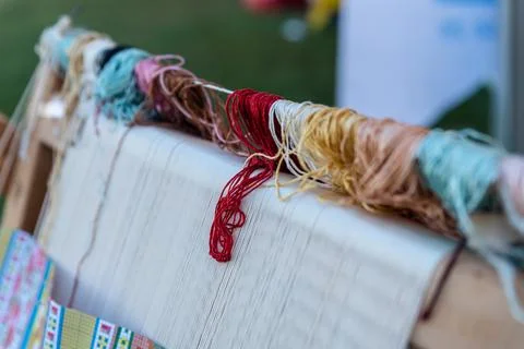 Carpet weaving using traditional techniques on a loom. , close-up of weaving and Stock Photos