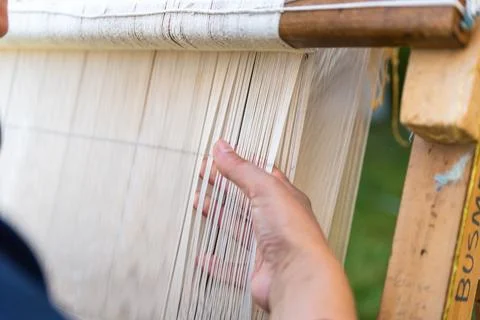 Carpet weaving using traditional techniques on a loom. , close-up of weaving and Stock Photos