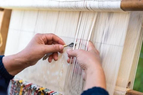 Carpet weaving using traditional techniques on a loom. , close-up of weaving and Stock Photos