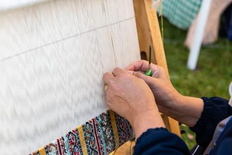 Carpet weaving using traditional techniques on a loom. , close-up of weaving and Stock Photos