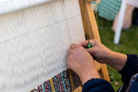 Carpet weaving using traditional techniques on a loom. , close-up of weaving and Stock Photos