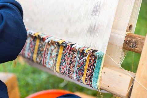 Carpet weaving using traditional techniques on a loom. , close-up of weaving and Stock Photos