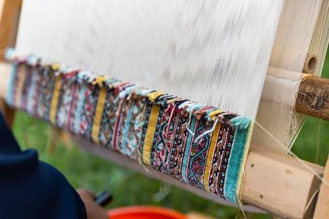 Carpet weaving using traditional techniques on a loom. , close-up of weaving and Stock Photos