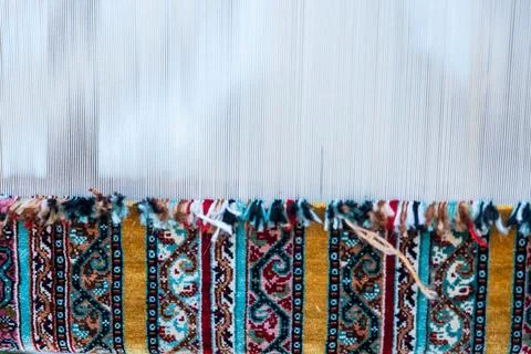 Carpet weaving using traditional techniques on a loom. , close-up of weaving and Stock Photos