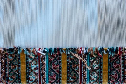 Carpet weaving using traditional techniques on a loom. , close-up of weaving and Stock-Fotos