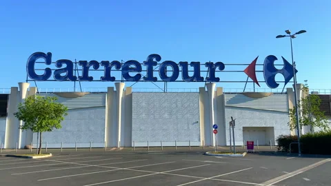Carrefour Rives d'Arcins store facade and empty parking lot Stock Footage 153463546
