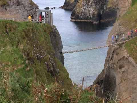 Carrick-a-Rede Rope Bridge - Tourists crossing bridge Stock Footage