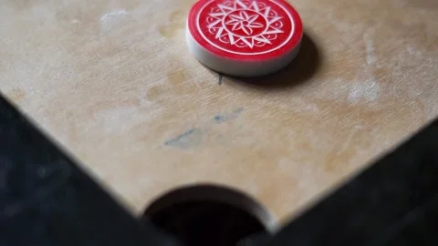 Carrom Board Playing hitting Red Queen with Striker and gets into pocket Video stock 197806098