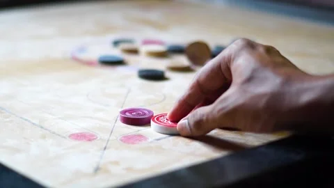 Carrom Board Playing hitting Red Queen with Striker - Indian game Video stock 197806102