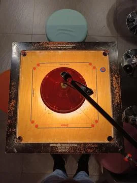 Carrom table is ready with arranged discs and striker. indoor summer activities, Stock Photos