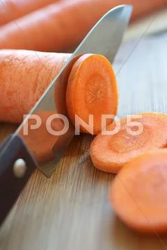 A carrot being sliced Stock Photos