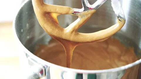 Carrot cake batter dough mix dripping off mixer, delicious dessert Stock Footage 230040919