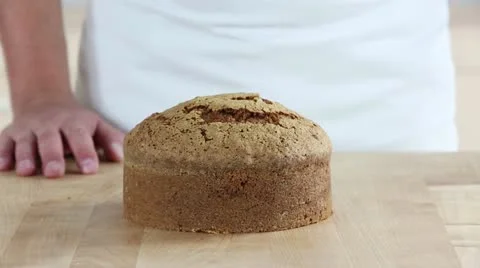 Carrot cake being sliced twice horizontally Stock Footage 24671677