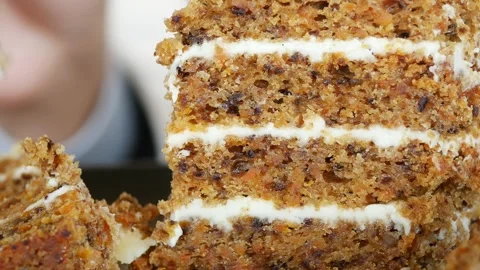 Carrot cake layers being sliced and served at a gathering Stock Footage 306568951