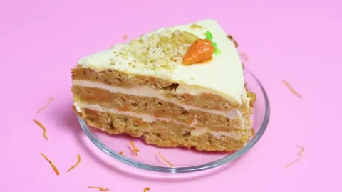 Carrot cake slice on a clear plate, layered spiced sponge with cream cheese Stock Footage 321532935