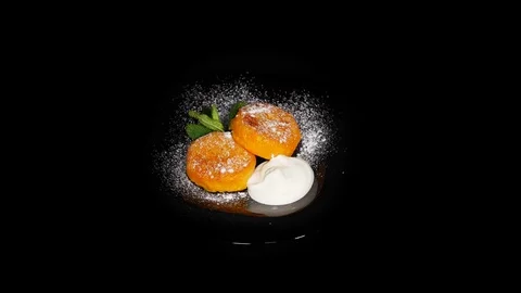Carrot cutlets in the spinning table isolated on black background in black plate 스톡 동영상 104721935