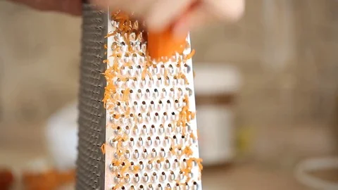 Carrot grating on metal grater Stock Footage 81268258
