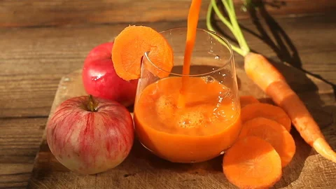 Carrot juice in glass on  table Stock Footage 102629652