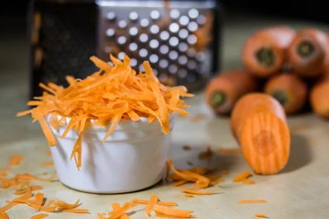 Carrot on the kitchen table. Vegetable grater. Kitchen table. Stock Photos