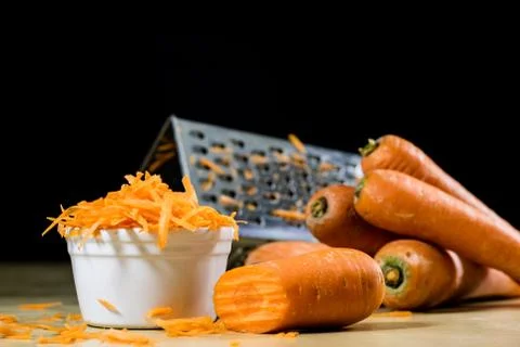 Carrot on the kitchen table. Vegetable grater. Kitchen table. Stock Photos