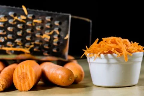 Carrot on the kitchen table. Vegetable grater. Kitchen table. Stock Photos