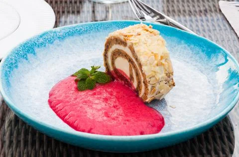 Carrot roll with raspberry mousse in a restaurant Stock Photos