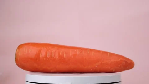 Carrot rotating on a pink background. Stock Footage 260795186