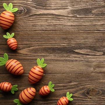 Carrot shaped Easter eggs on rustic wooden background Stock Photos
