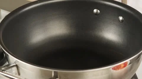 Carrots and pepper being added to a pan of hot oil Stock Footage 24672879