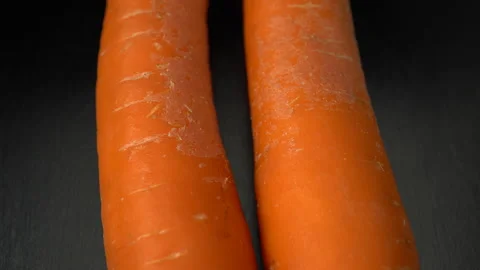 Carrots on a black background close-up. Video stock 147722084