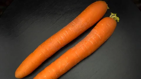 Carrots on a black background close-up. Stockbeeldmateriaal 147853181
