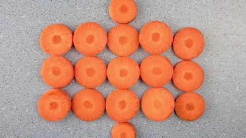 Carrots cut into round slices. Fresh carrots, vegetables kitchen, animation. 스톡 동영상 294355000