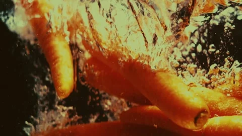 Carrots Drop Chaotically in Water Stock Footage 300890346