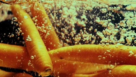 Carrots Drop in Water Chaotically Stock Footage 300892774