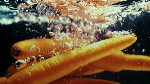 Carrots Drop in Water Stock Footage 300892773